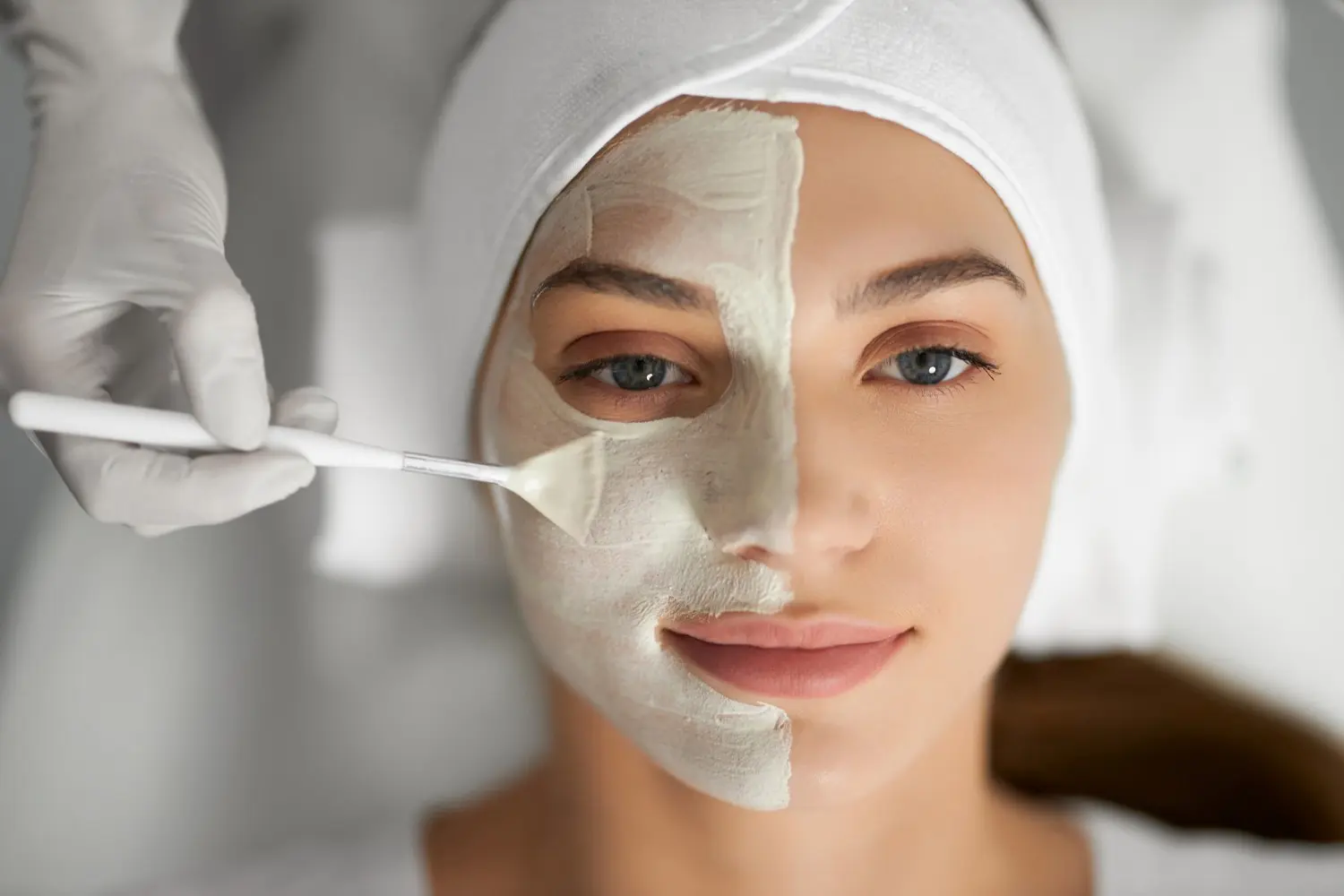 A woman with white face mask on her head.